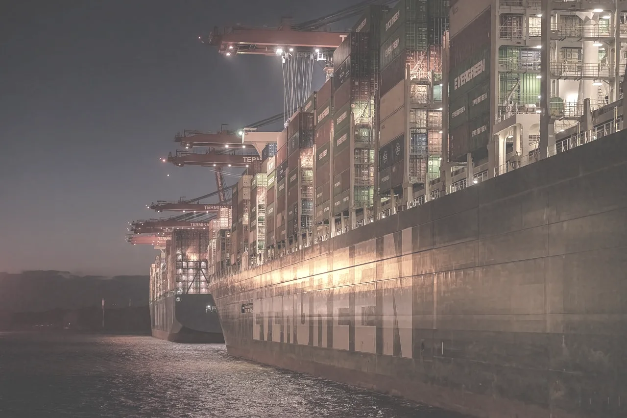 A container terminal working under floodlight at night